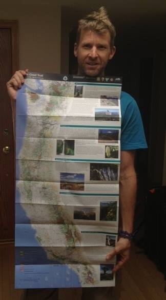 Hudson holds a map of the Pacific Crest Trail