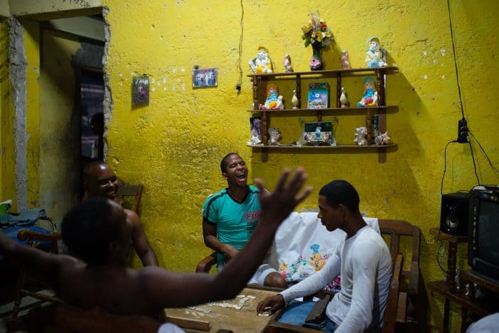 In the poor neighborhood of Juruquey in Camaguey, Cuba, shown on February 3, Yasmany Garcia, 26, in green, screams with excitement at the end of a round of dominos with his friends at his home. Camaguey is Cuba's third largest city with more than 321,000 residents.