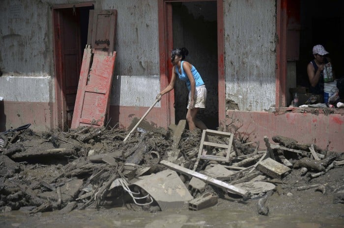 Residents clean a home after a landslide in Salgar municipality, Antioquia, Colombia on May 18, 2015.
