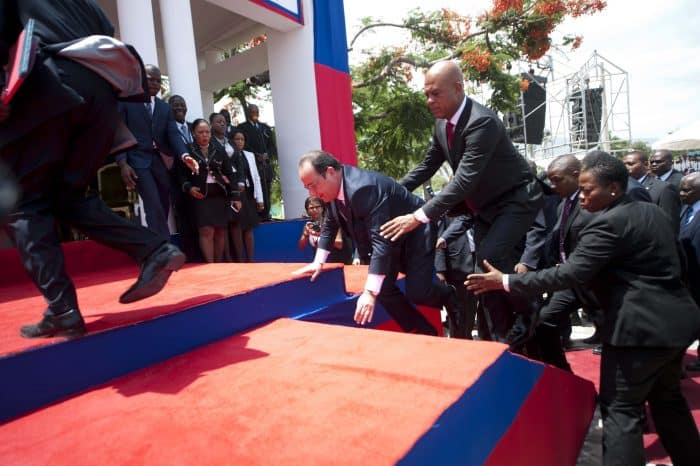Haitian President Michel Martelly, right, assists French President Francois Hollande, who missed a step at official ceremonies, in Port-au-Prince, Haiti, on May 12, 2015.