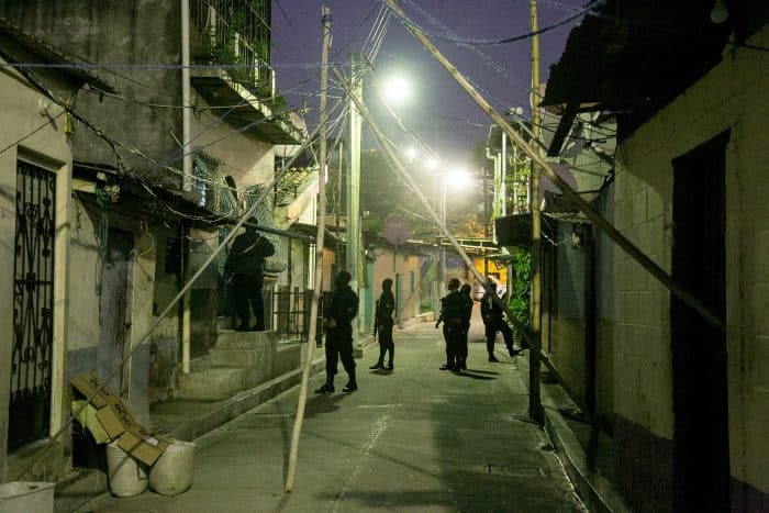 A house-by-house search for gang members in San Salvador.