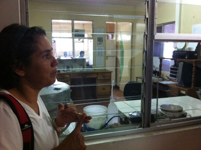 Rossy Araya, tour guide at Monteverde Cheese Room, points out the lab where milk is tested.