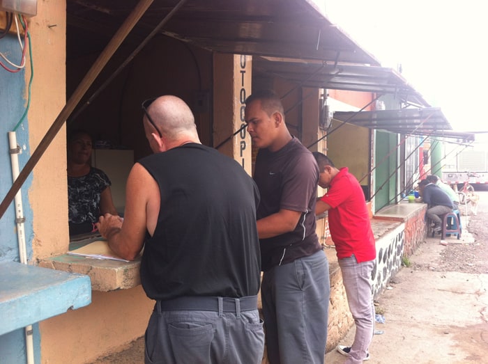 Paul gets photocopies with our border fixer, Luis.