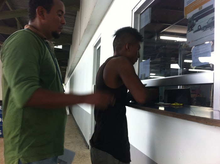 Gabriel waits behind another person trying to insure his car in Costa Rica.