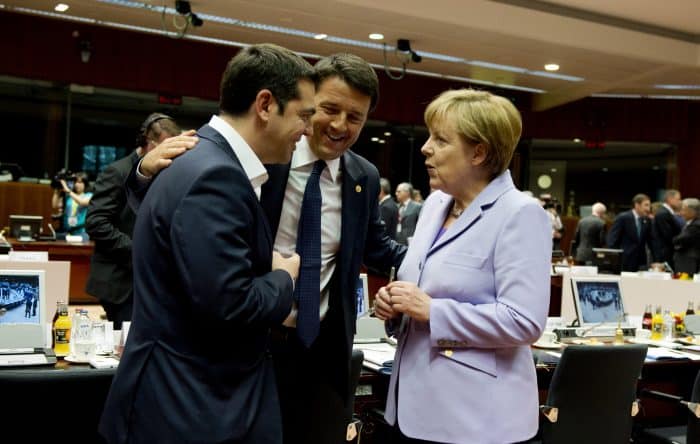 German Chancellor Angela Merkel, right, speaks with Greek Prime Minister Alexis Tsipras, left, and Italian Prime Minister Matteo Renzi.