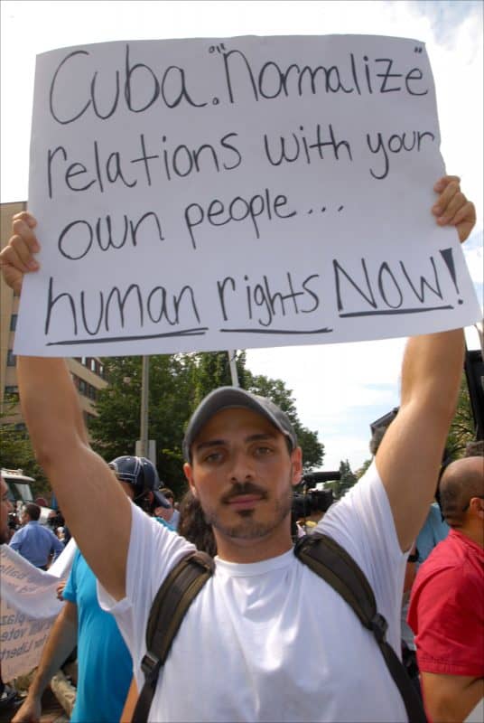 Protester in front of Cuban Embassy in Washington urges Cuba to come clean on human rights and release all political prisoners, July 20, 2015.