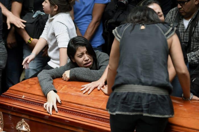 Relatives and friends of murdered Mexican photographer Rubén Espinosa mourn at the Dolores Cemetery in Mexico City, on Aug. 3, 2015.