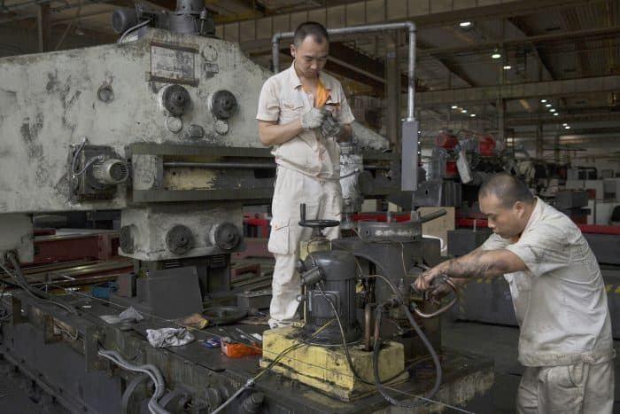 Factory workers are seen working in the Shenyang Machine Tool (Group) Co., Ltd. milling workshop in Shenyang, China on Aug. 19.