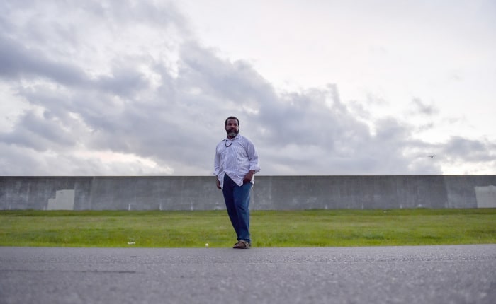 Keith Allen is pictured in front of the levee across from his home.