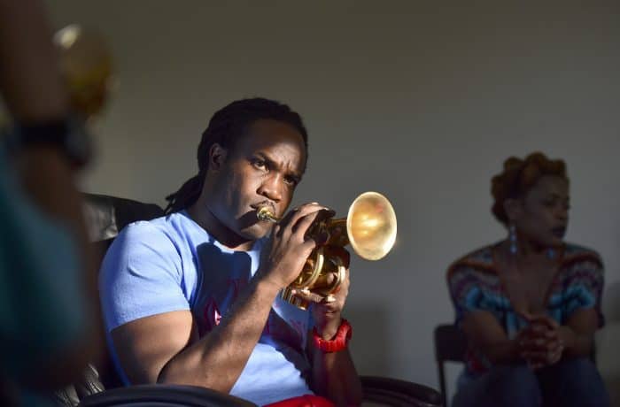 Keith Allen's son Shamarr teaches music to local children.
