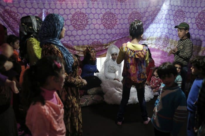 A 15-year-old bride receives well-wishers at a Syrian refugee settlement near Tripoli, Lebanon.