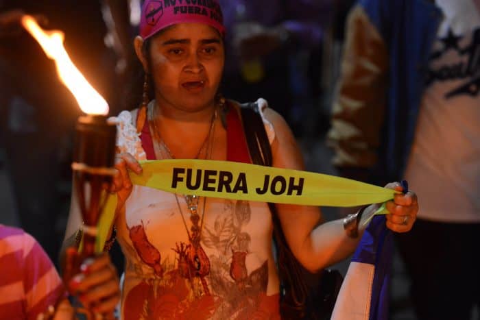 A protester calls for Honduran President Juan Orlando Hernández to step down.