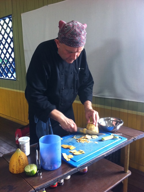 Alejandro Corral slices into a cacao fruit.