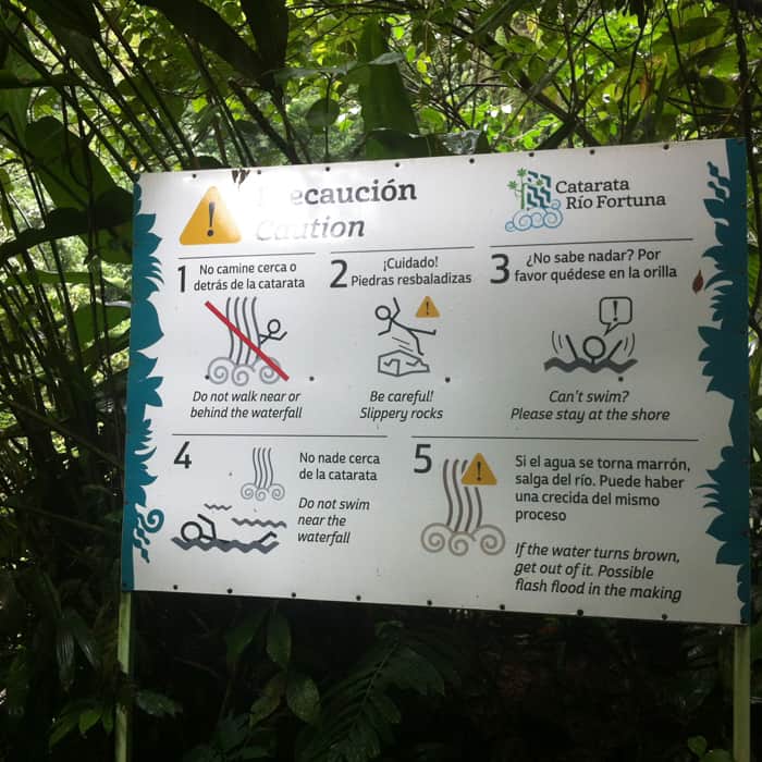 A warning sign fails to warn swimmers not to venture into deeper waters to the right and left of the pool.
