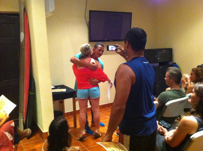 Congratulations and hugs at Witch's Rock Surf Camp graduation.