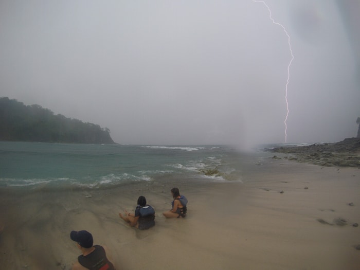 Lightning strikes the ocean off Sámara as stranded kayakers sit on Isla Chora.