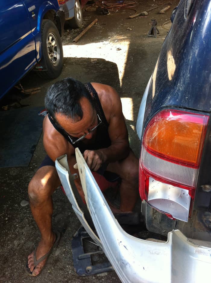 Jorge hard at work, reattaching our bumper.