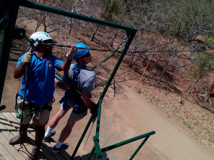 The author hooks his elbows to the rail in preparation for the Tarzan swing.