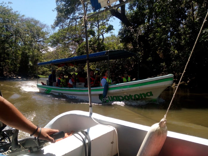 A boatful of journalists, viewed from another one.