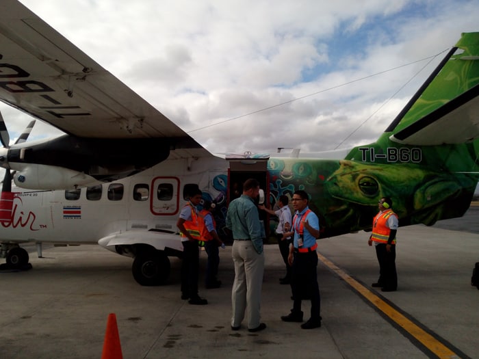 Nature Air commercial director Nelson Vega (not wearing orange) greets staff in Managua.