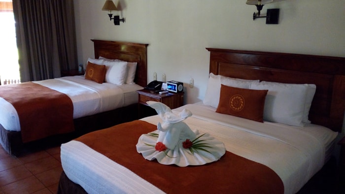 Sumptuous beds at Casa Conde — with the "Tico swan towel" reimagined as an elephant.