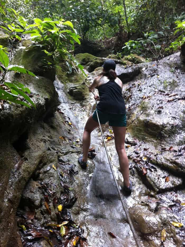 Mia climbs a waterfall.