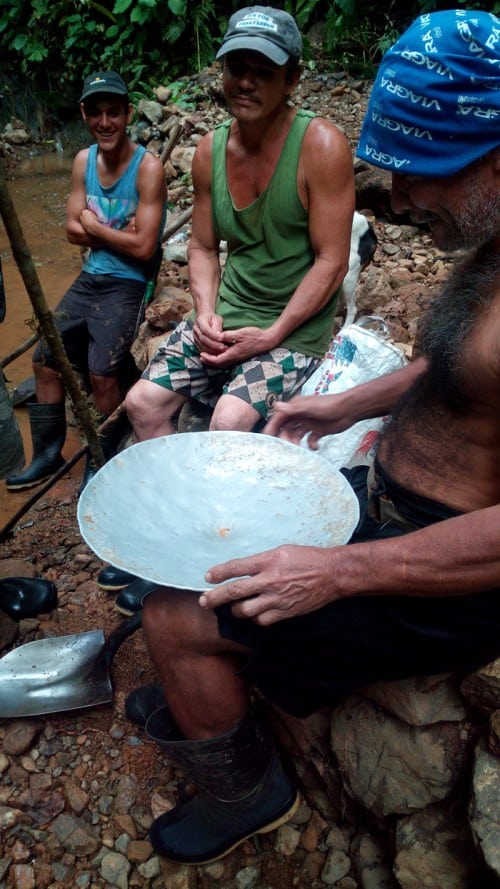 Three gold miners prepare to show off the day's find.