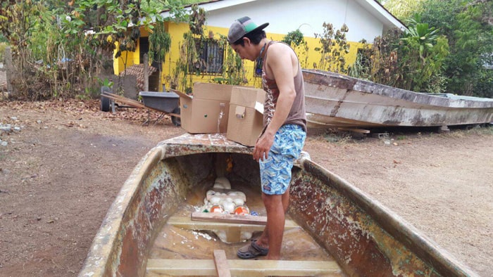 Alberto Robleto Jr. stands in a flotation-challenged boat.