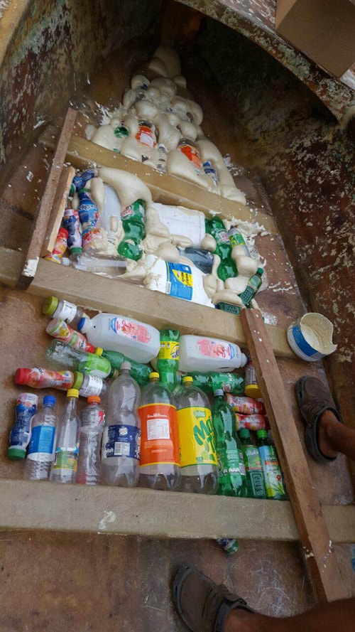 Empty bottles in boat, ready to be fixed in place with foam.