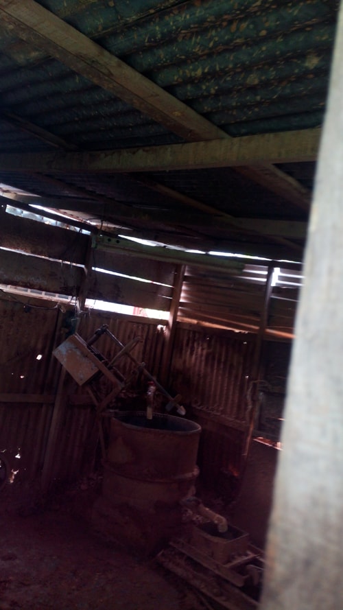 A peek at a clay mixer past a locked door.