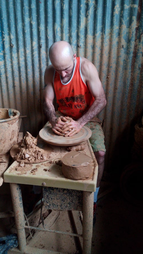 The clay is smashed into shape.