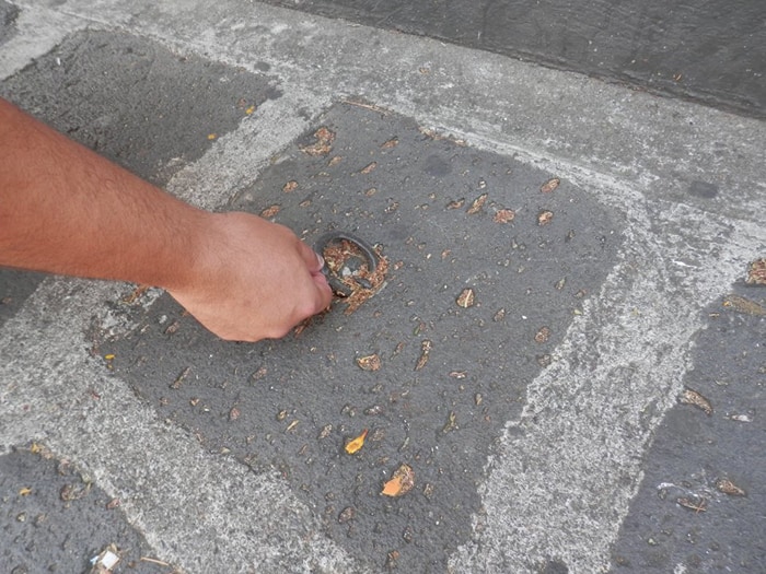 A ring in a sidewalk once used to tether horses.