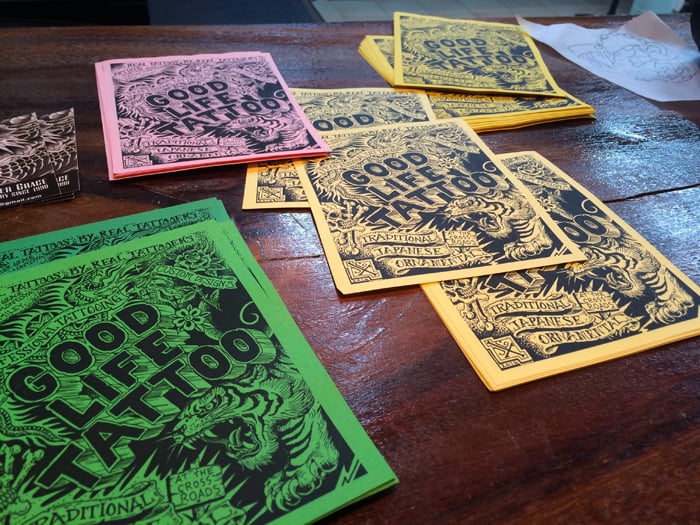 Flyers on the front desk at Good Life Tattoo.