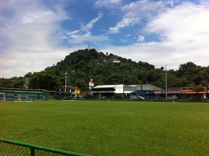 Soccer field in Quepos, with nice houses on the hills behind.