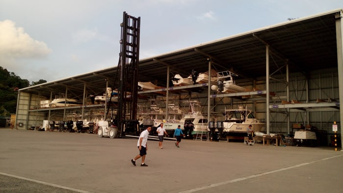 "Beast," the huge forklift, stands ready to raise and lower boats from the dry rack in the Marina Pez Vela yacht yard.