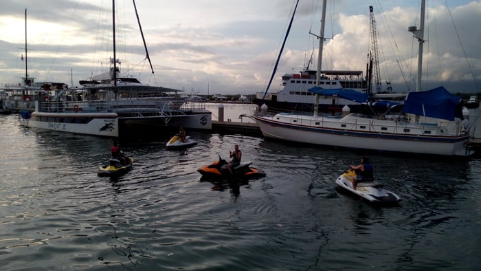 Jet-skiers return from some adventure in the ocean.