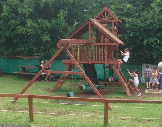 Swinging and sliding right beside the mall.
