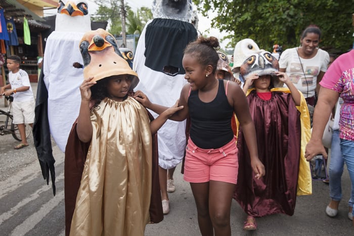 Two girls walk together in the first-ever Parade of the Birds.