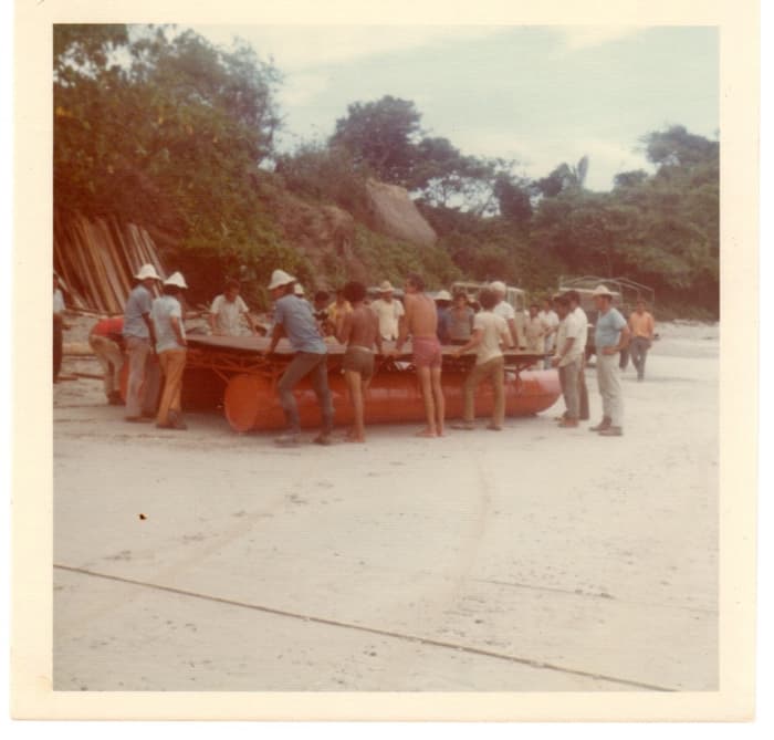 An old photo showing a raft used to bring materials ashore in the 1970s.
