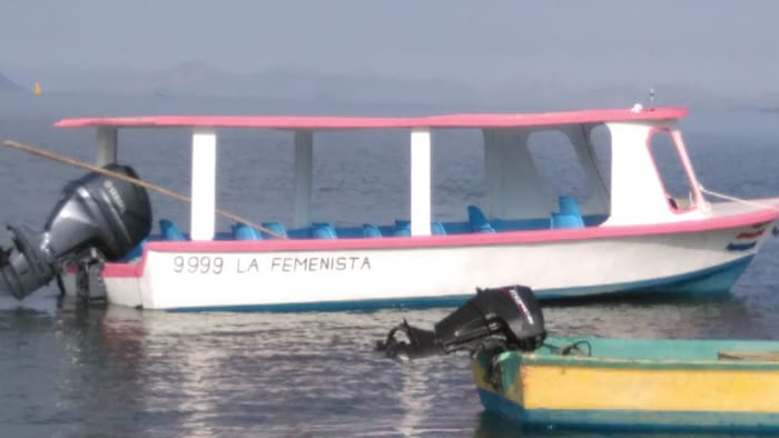 One local woman is working hard to create jobs and income for local women via recycled art and tours of the gulf. The tours utilize the boat shown here. The captain is her husband, and the name and color scheme have no doubt caused him some grief at the local watering hole.