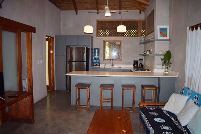 Living room and kitchen at a home for sale represented by Surfing Nosara.