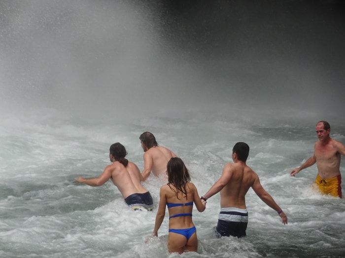 Braving the fierce currents at the base of La Fortuna Waterfall.