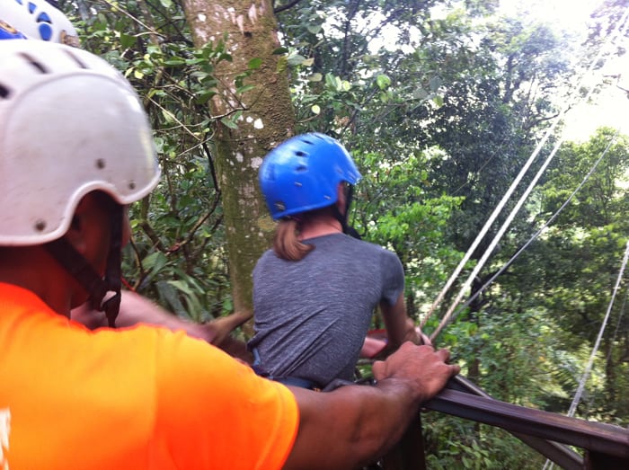 A brave young girl gets set for the Tarzan swing.