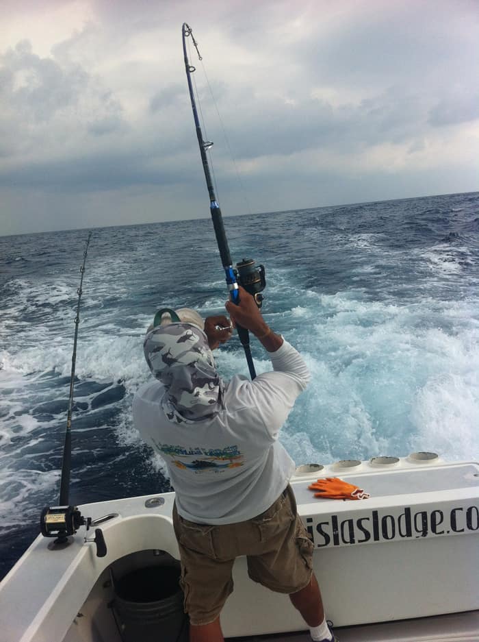 Jesús hooks a small but feisty tuna that is about to become bait.